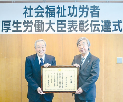 写真：表彰状を受け取る木村さん（左）