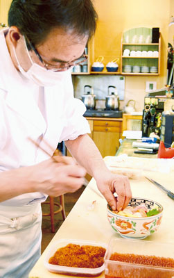 写真：人気の海鮮丼を調理する大将の佐藤さん