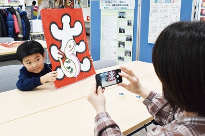 写真：出来上がった凧を手に記念撮影する親子