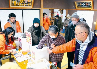 写真：運試しの抽選を行う地域住民ら