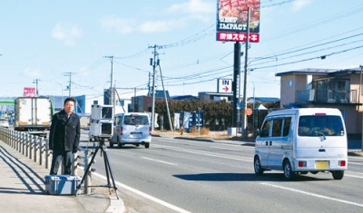 写真：可搬式速度違反自動取締装置で取り締まりを行う室蘭署員