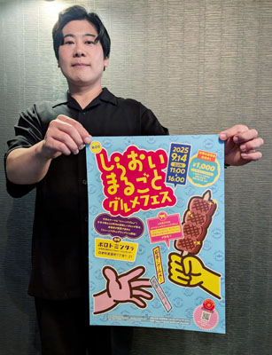 写真:ポスターを手に来場を呼びかける青山部長