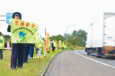 写真:国道37号沿いでスピードダウンを呼びかける市交通安全推進協の関係者