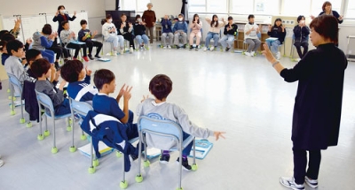 写真:手話であいさつや指文字を練習する児童たち