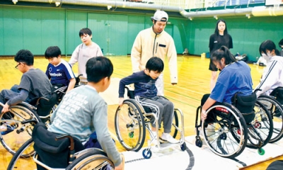 写真:マットを使い、車いすを操る技術を上達させる児童ら