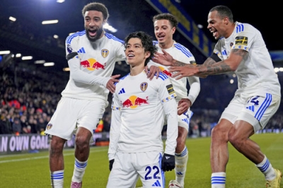 写真:チェルシー戦でリーグ初得点を決め、チームメートと喜ぶ田中(中央)=リーズ(AP=共同)