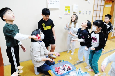 写真:休み時間に交流を深める「すみっこぐらし」のメンバーと児童