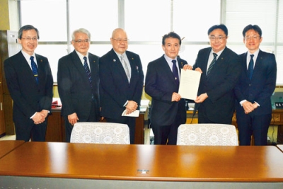 写真:小笠原市長へ提言書を手渡す千田議長(右から3人目)と戸井委員長(同4人目)