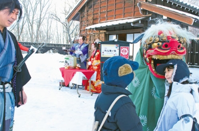 写真:獅子舞が登場し、来村者の頭をかむおもてなし
