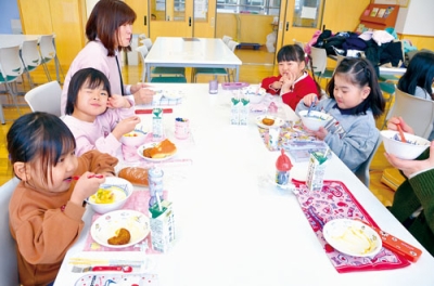 写真:初めての学校給食を味わう園児たち