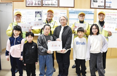 写真:代表児童から手紙を受け取り、笑みを見せる交通安全指導員ら