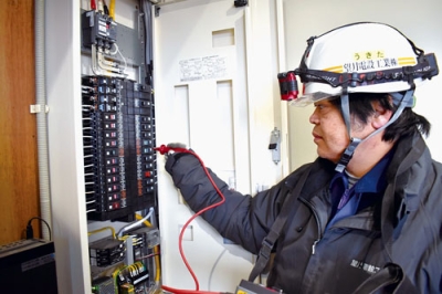 写真:電気回路に異常がないか確認する協会加盟社の従業員